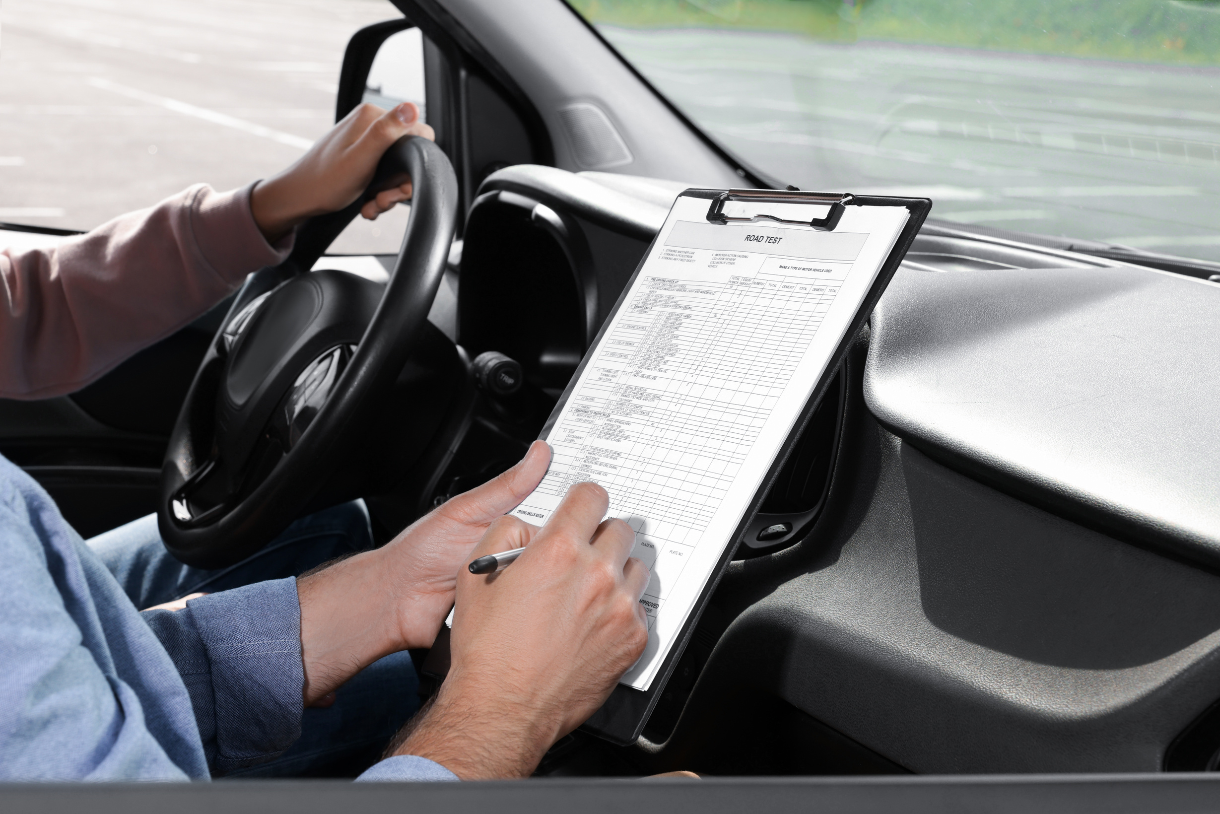 Driving School. Student Passing Driving Test with Examiner in Ca